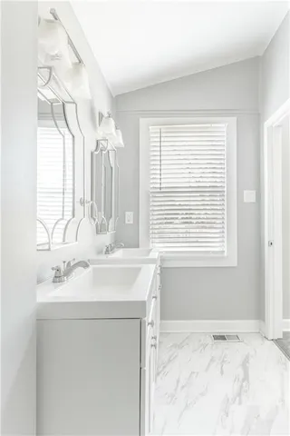 a bathroom with a sink vanity and a mirror