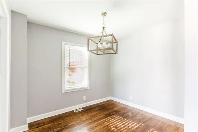 a view of a room with wooden floor and windows