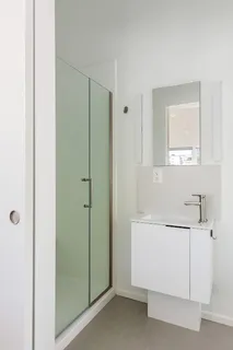 a living room with furniture and a view of kitchen