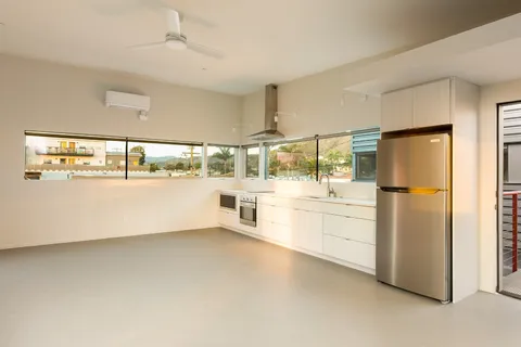 a kitchen with stainless steel appliances granite countertop a stove a refrigerator and a white cabinets