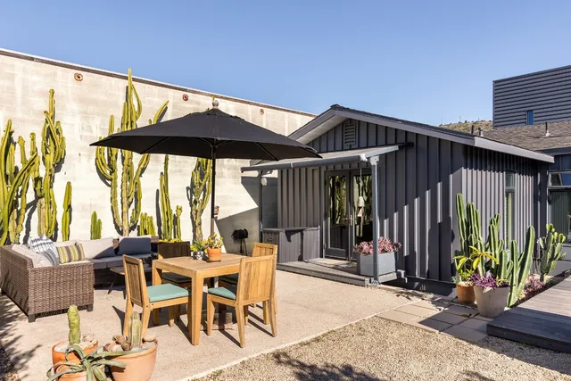 a patio with a patio table and chairs