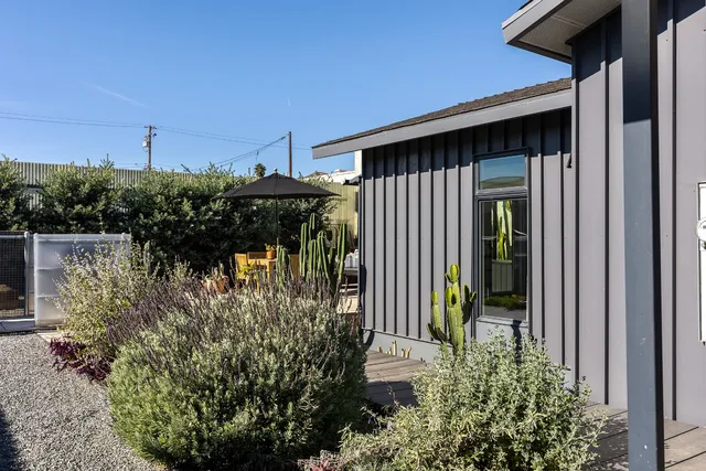 a backyard of a house with table and chairs
