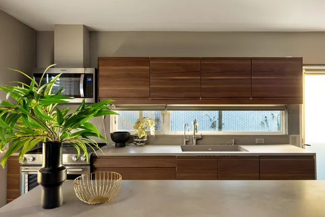 a living room with furniture a window and a chandelier