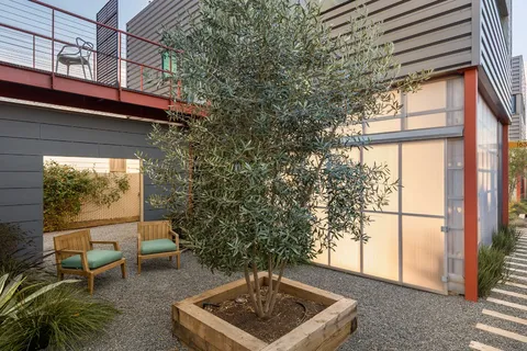 a vase of flowers sitting on a table in front of a building