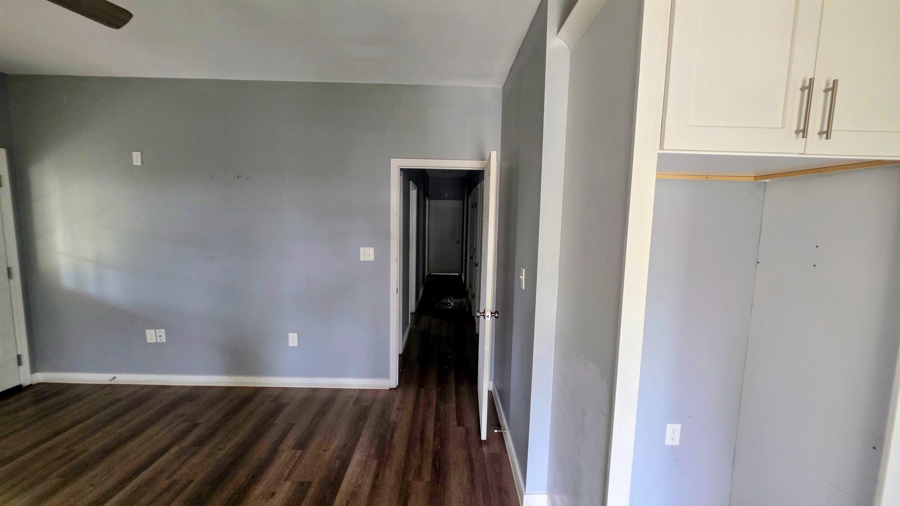 1551 Cane Road Memphis, TN 38106 - Photo 5 of 5 Room featuring wood-finish flooring, light gray walls, white trim, and a ceiling fan