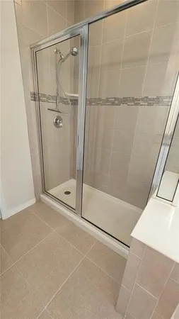 a bathroom with a glass shower door