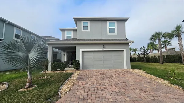 a front view of a house with a yard and garage