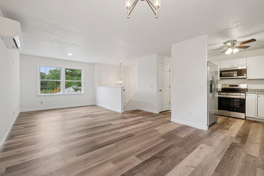 4 Hill Lane Shirley, MA 01464 - Photo 11 of 38 wooden floor in an empty room with a kitchen