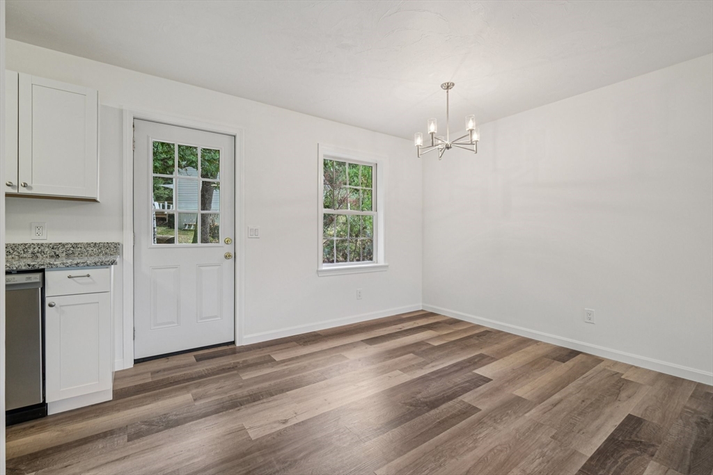 4 Hill Lane Shirley, MA 01464 - Photo 13 of 38 an empty room with wooden floor a ceiling fan and windows