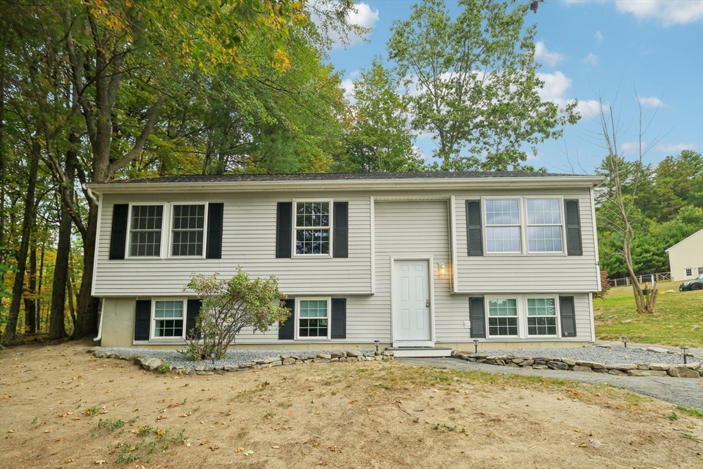 4 Hill Lane Shirley, MA 01464 - Photo 3 of 38 a front view of a house with a yard