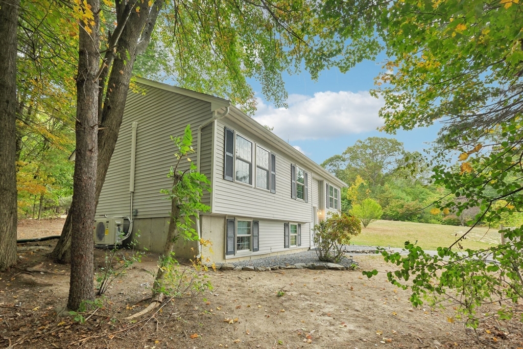 4 Hill Lane Shirley, MA 01464 - Photo 5 of 38 a house that has a tree in front of the house