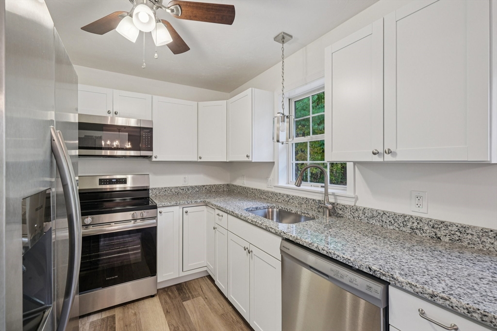 4 Hill Lane Shirley, MA 01464 - Photo 9 of 38 a kitchen with granite countertop a sink stainless steel appliances and cabinets
