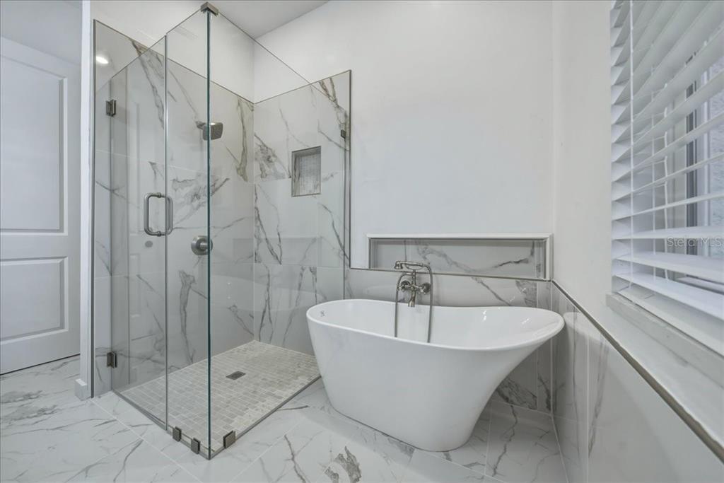 1215 Rio De Janeiro Avenue Punta Gorda, FL 33983 - Photo 49 of 65 a white bath tub sitting next to a shower