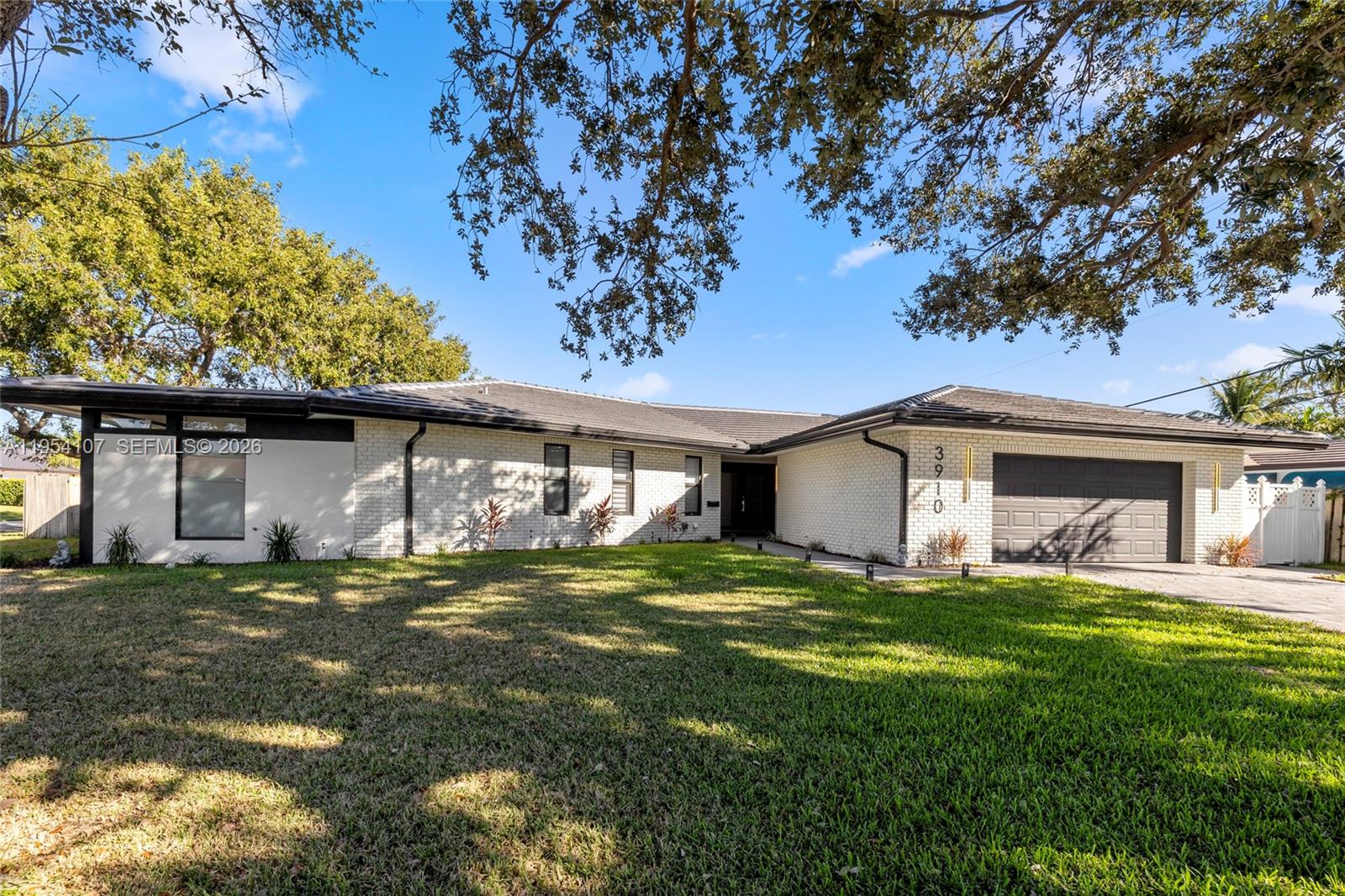 3910 Northeast 27th Terrace Lighthouse Point, FL 33064 - Photo 1 of 55 a house view with a garden space