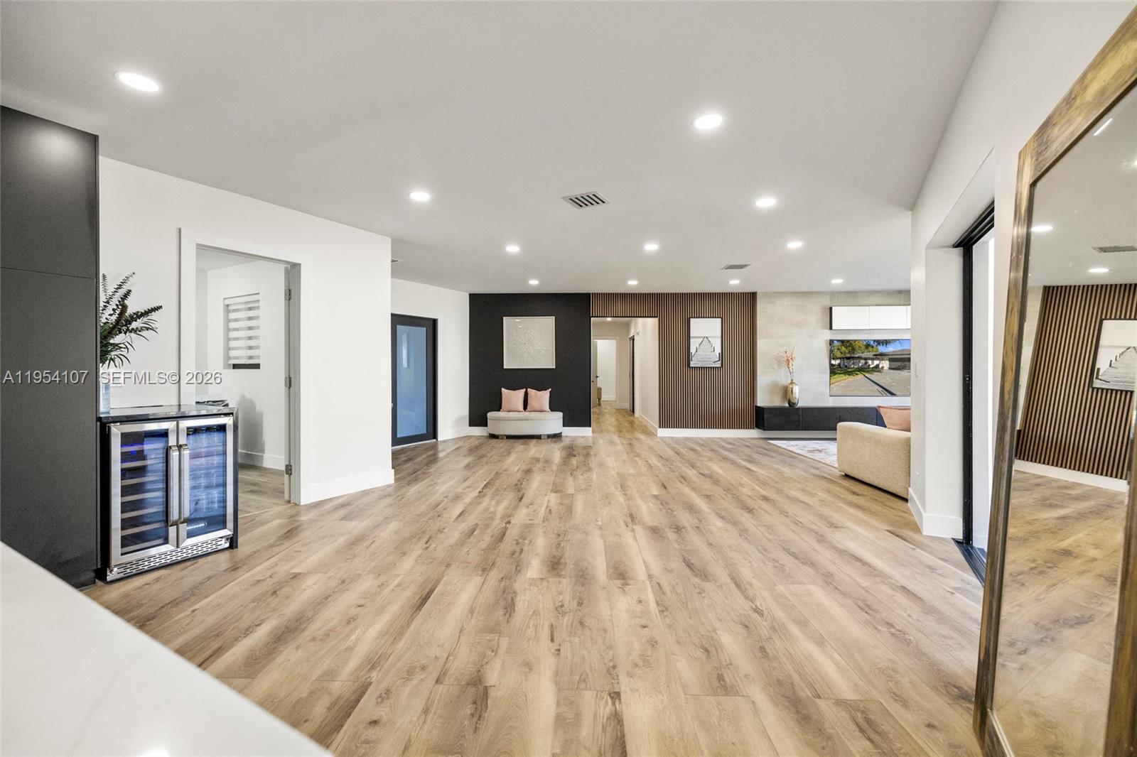 3910 Northeast 27th Terrace Lighthouse Point, FL 33064 - Photo 15 of 55 wooden floor and large windows in a hall with an entryway of the house