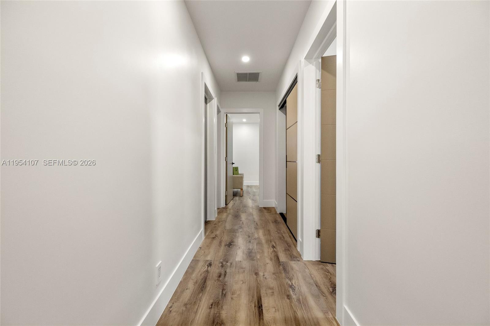 3910 Northeast 27th Terrace Lighthouse Point, FL 33064 - Photo 16 of 55 a view of a hallway with wooden floor