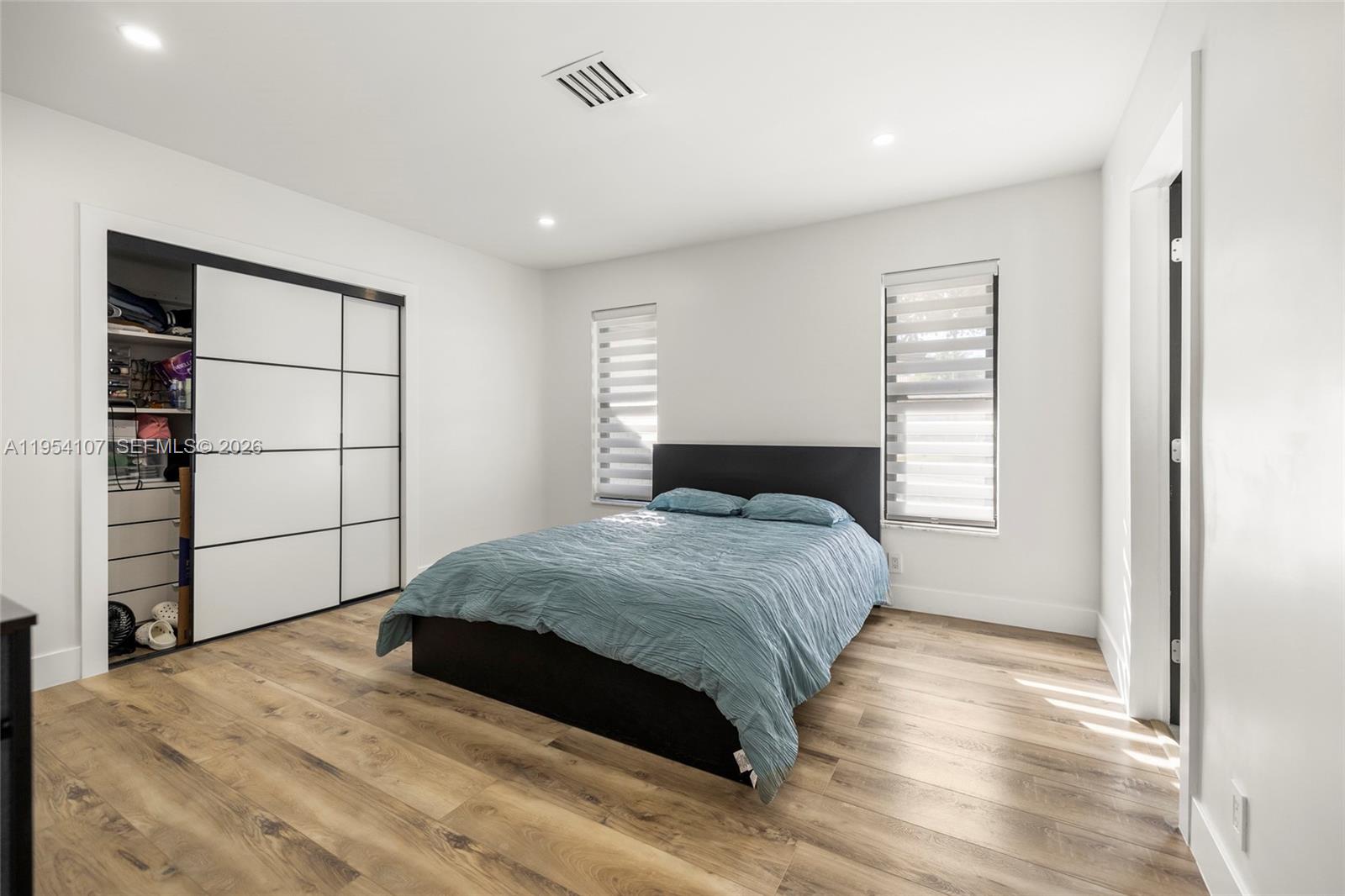 3910 Northeast 27th Terrace Lighthouse Point, FL 33064 - Photo 21 of 55 a bedroom with a bed and a window