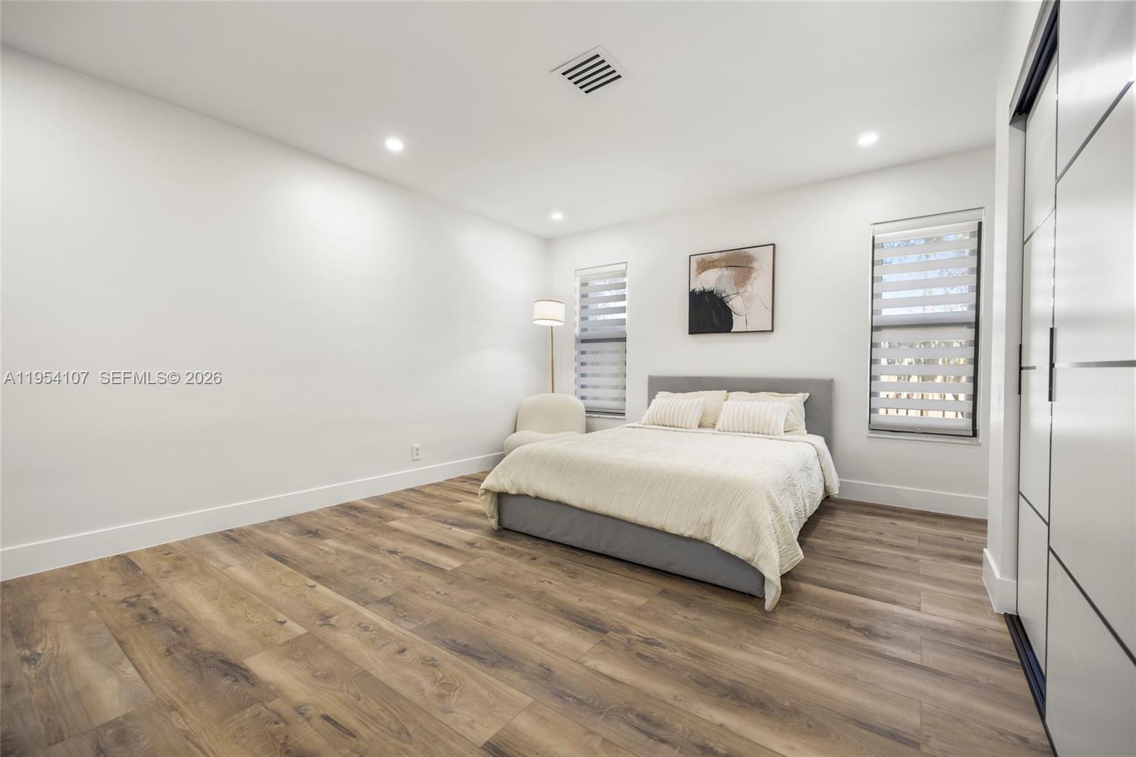 3910 Northeast 27th Terrace Lighthouse Point, FL 33064 - Photo 24 of 55 a spacious bedroom with a bed and a window