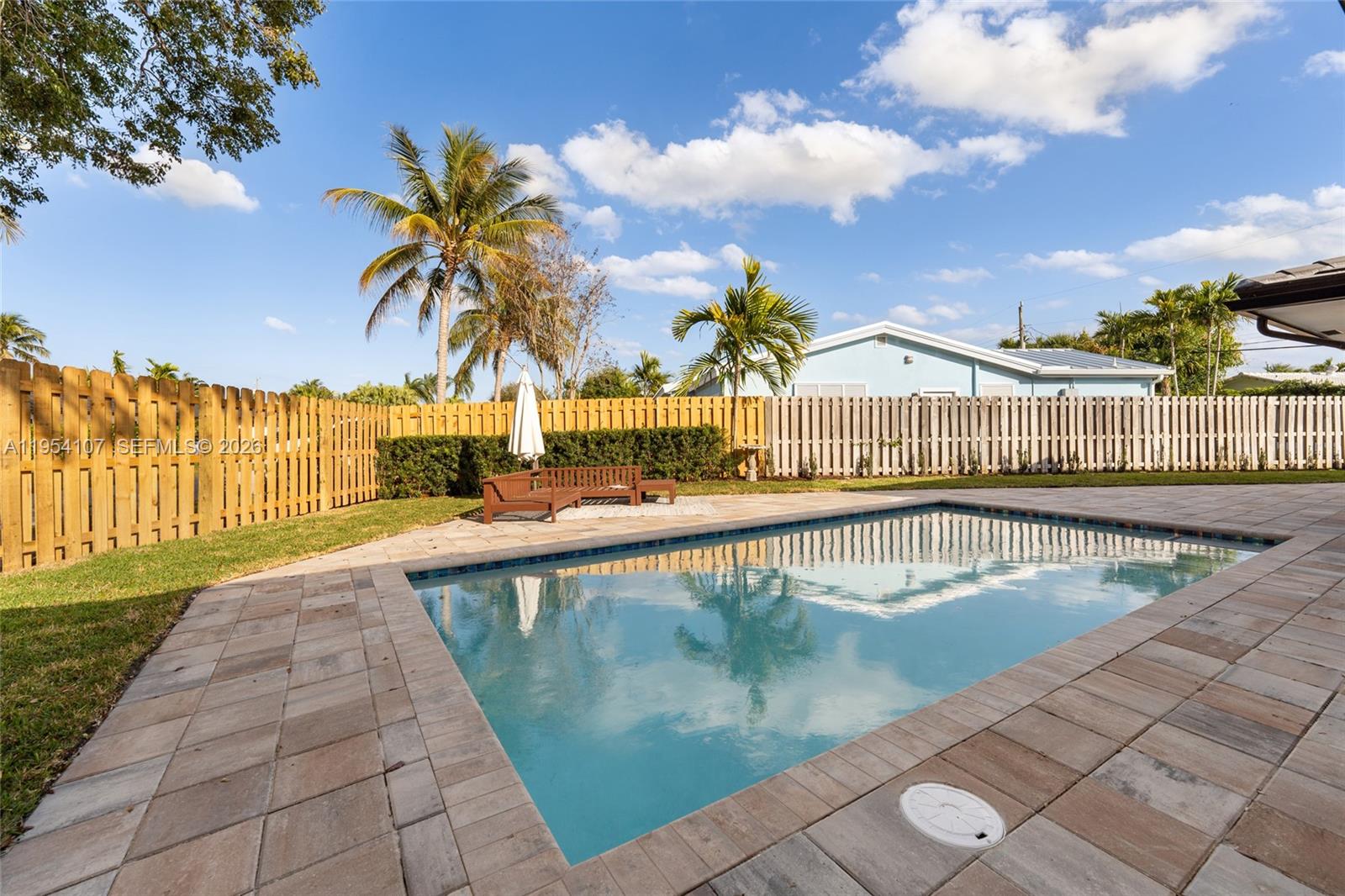 3910 Northeast 27th Terrace Lighthouse Point, FL 33064 - Photo 48 of 55 a view of swimming pool with outdoor seating and a garden