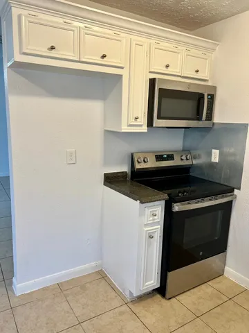 a kitchen with a sink cabinets and a window