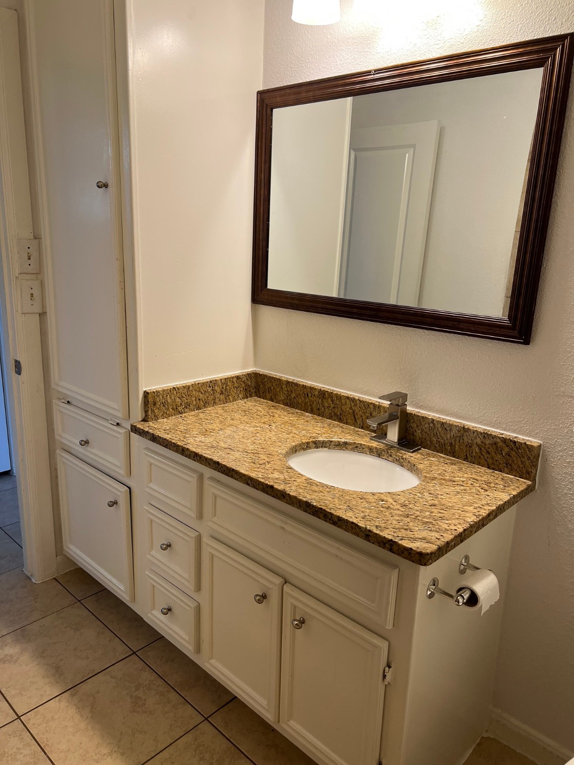 5136 Mallow Street, Unit B Houston, TX 77033 - Photo 9 of 14 a bathroom with a granite countertop sink and a mirror