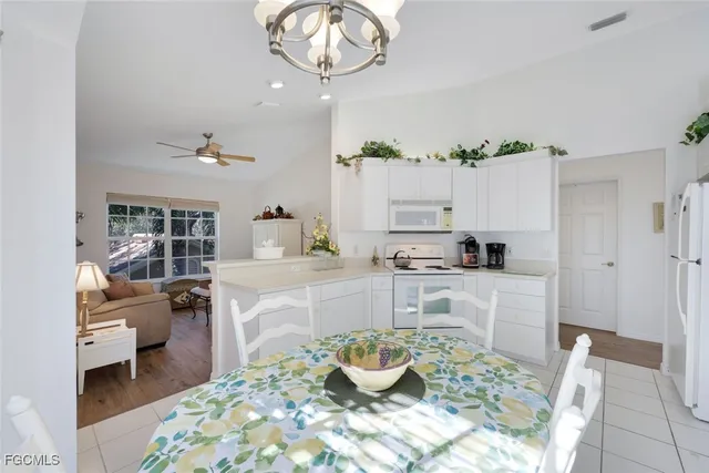 a kitchen with a table and chairs