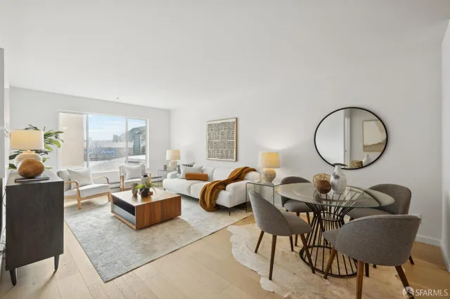a living room with furniture a table and a large window