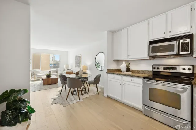 a living room with furniture a fireplace and a window