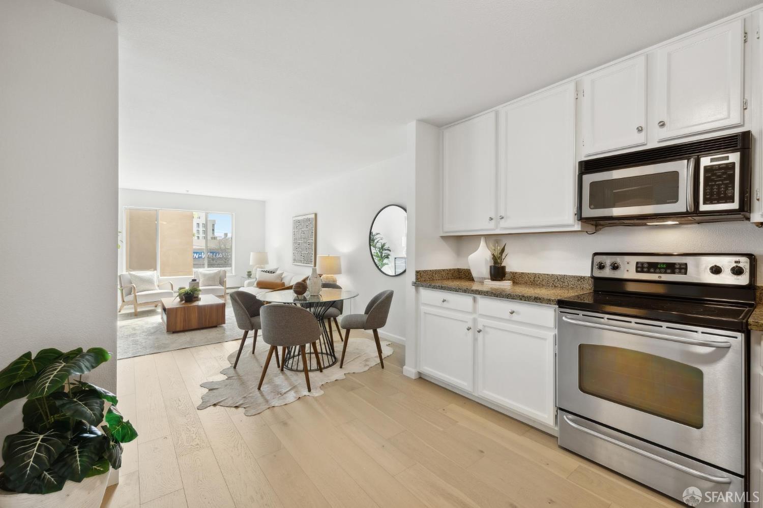 550 South Van Ness Avenue, Unit 207 San Francisco, CA 94110 - Photo 12 of 22 a living room with furniture a fireplace and a window
