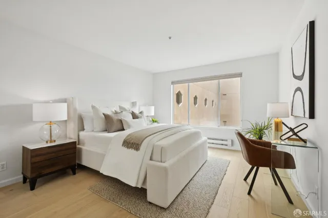 a bedroom with a bed a mirror and a window