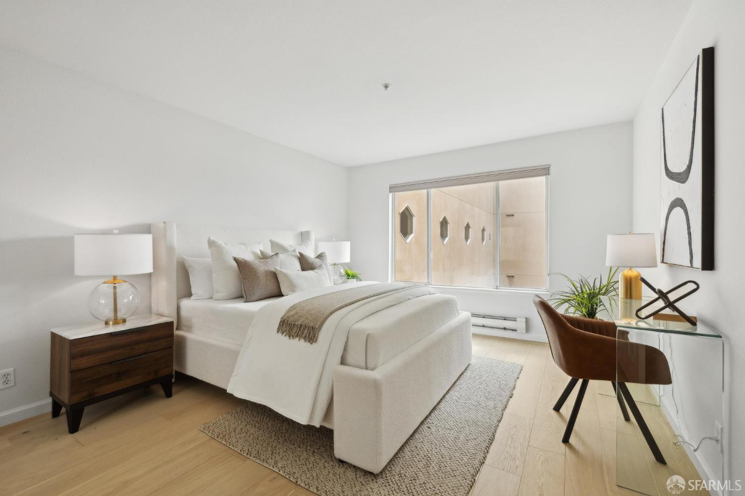 550 South Van Ness Avenue, Unit 207 San Francisco, CA 94110 - Photo 16 of 22 a bedroom with a bed a mirror and a window