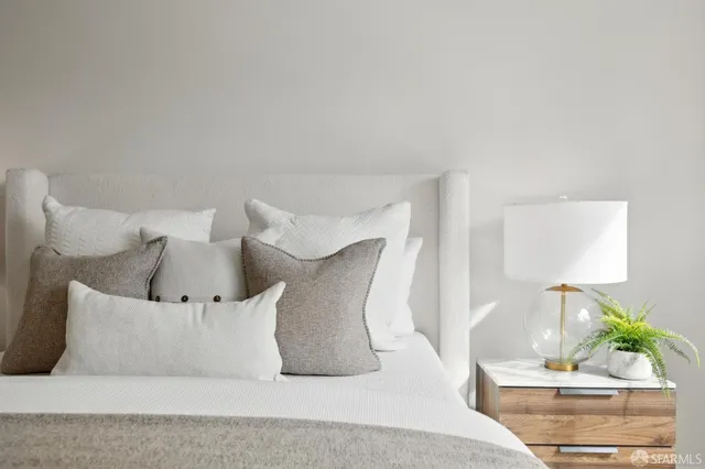a large white bed in a white room