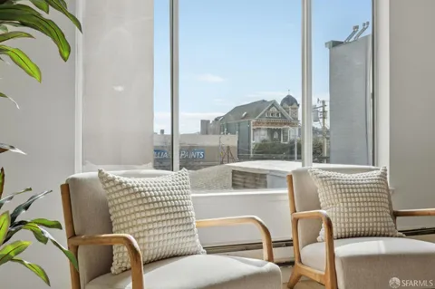 a living room with furniture and a floor to ceiling window