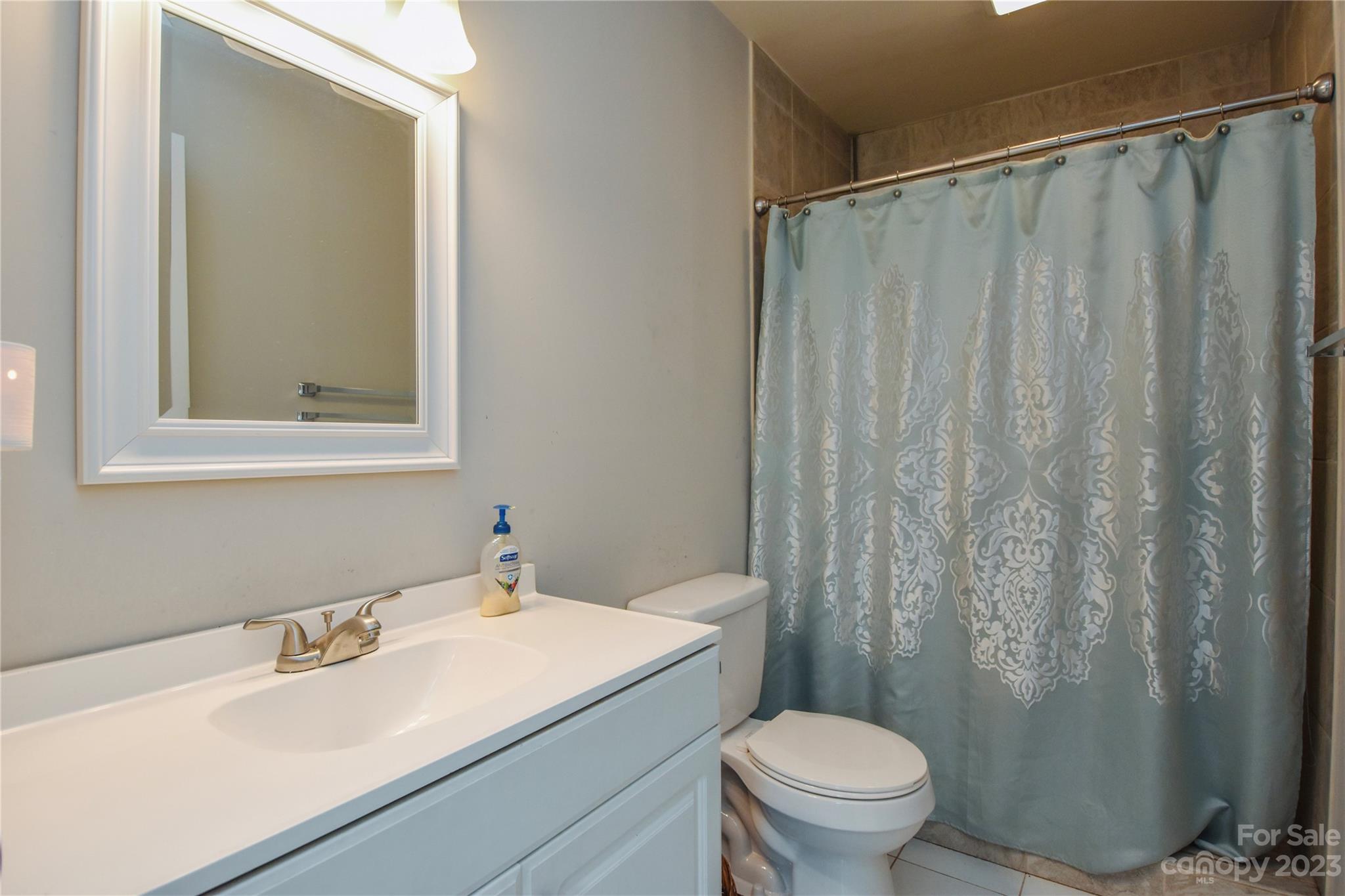 204 Springhill Lane Maiden, NC 28650 - Photo 11 of 20 a bathroom with a sink a toilet and shower curtain