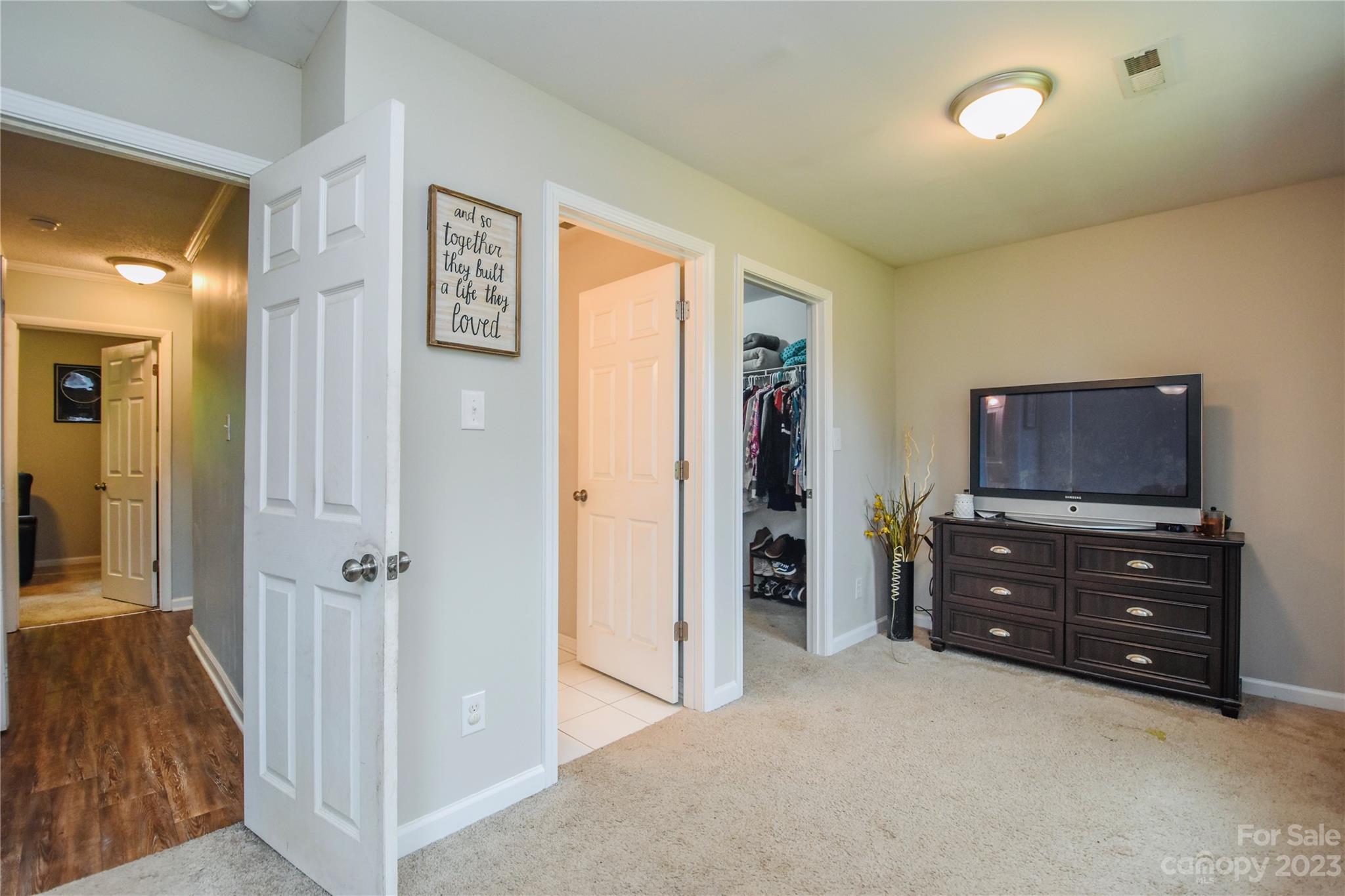 204 Springhill Lane Maiden, NC 28650 - Photo 10 of 20 a view of a bedroom with closet cabinet and a flat screen tv