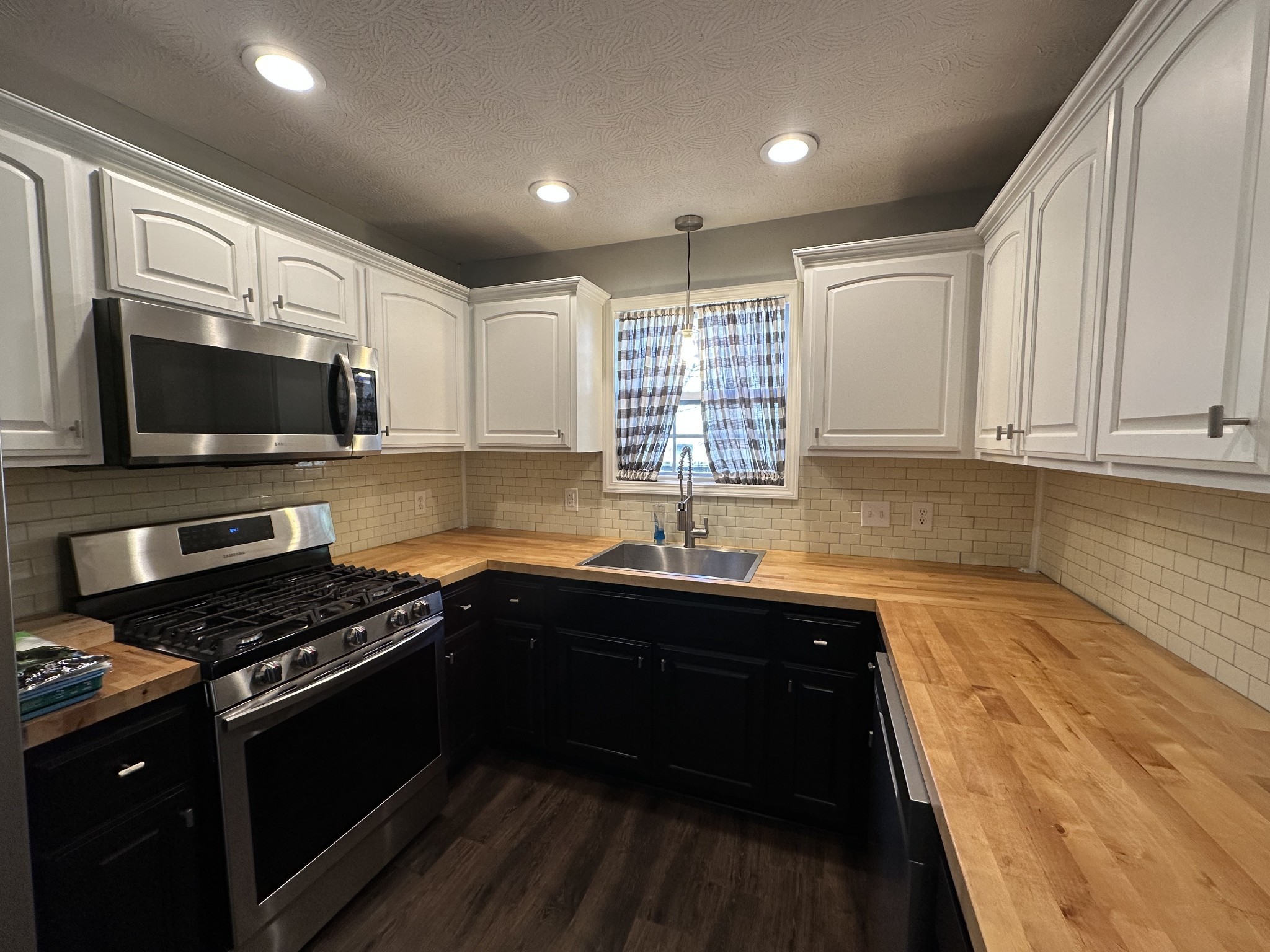 902 South Russell Street Portland, TN 37148 - Photo 11 of 13 a kitchen with a sink stove microwave and cabinets