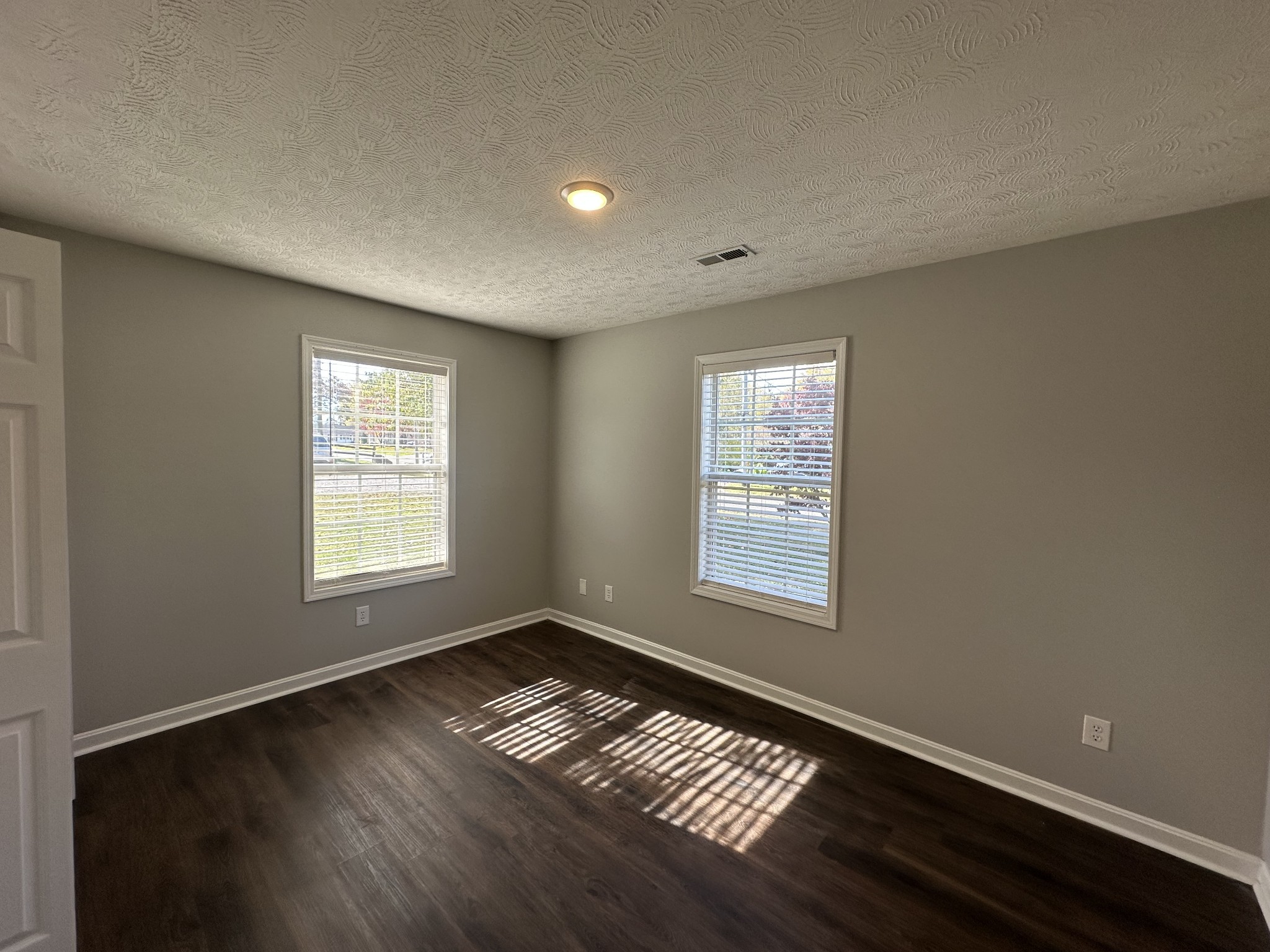 902 South Russell Street Portland, TN 37148 - Photo 12 of 13 a view of an empty room with wooden floor and a window