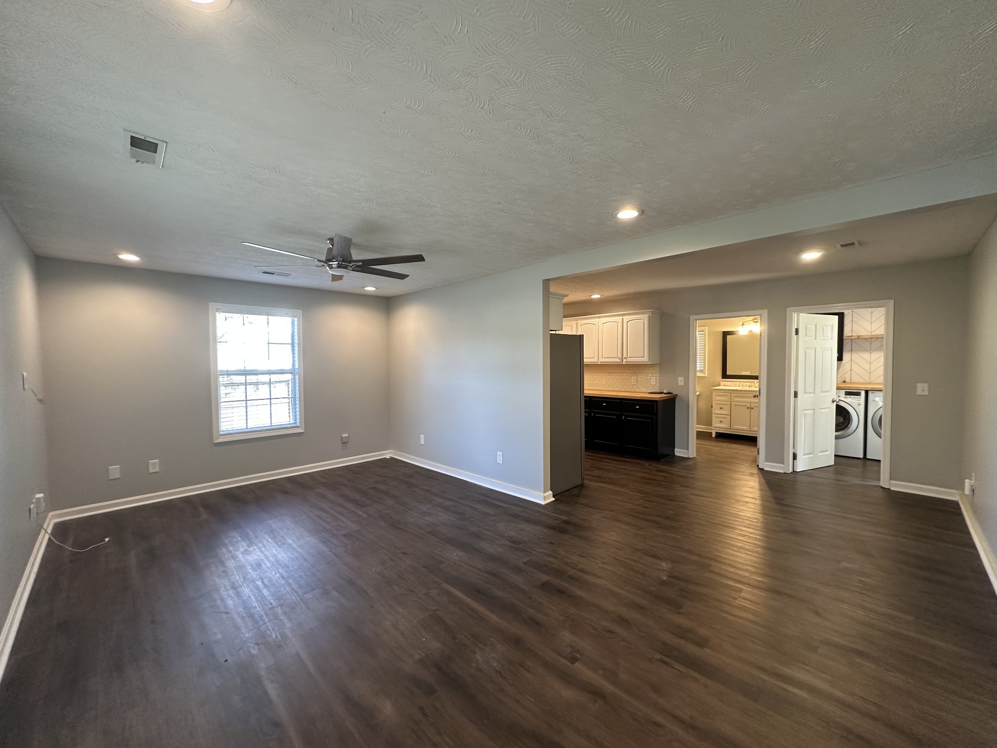 902 South Russell Street Portland, TN 37148 - Photo 8 of 13 a view of empty room with wooden floor and kitchen