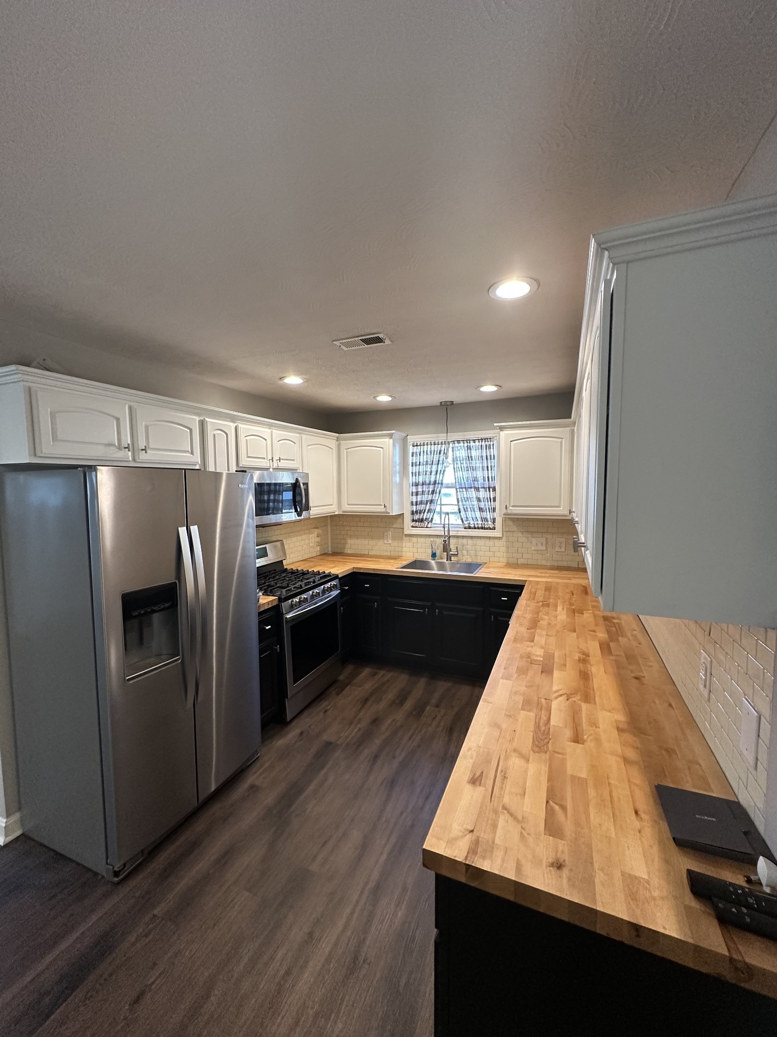 902 South Russell Street Portland, TN 37148 - Photo 10 of 13 a kitchen with stainless steel appliances granite countertop a refrigerator a sink and a stove