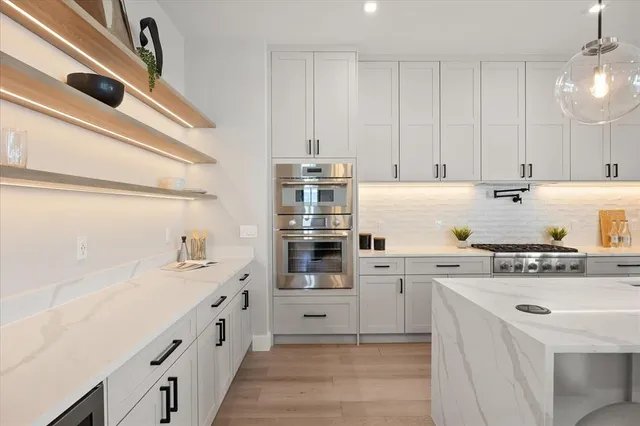 a kitchen with cabinets and appliances