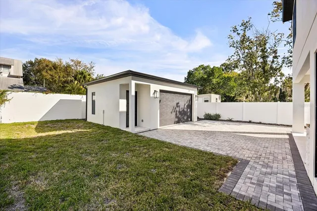 a view of a house with a yard and garage