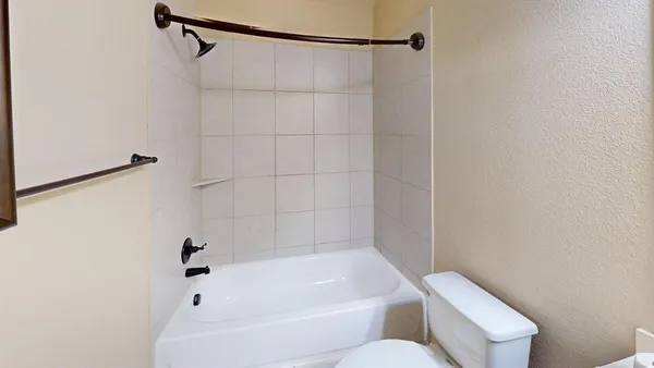 a bathroom with a bathtub and shower