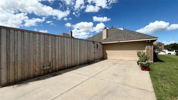 a view of a backyard with wooden fence
