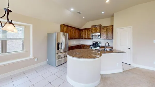 a kitchen with a sink a stove and refrigerator