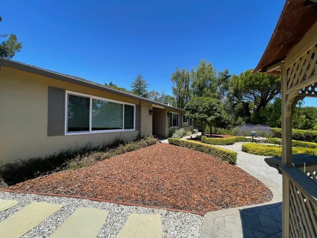 a view of a house with swimming pool and sitting area