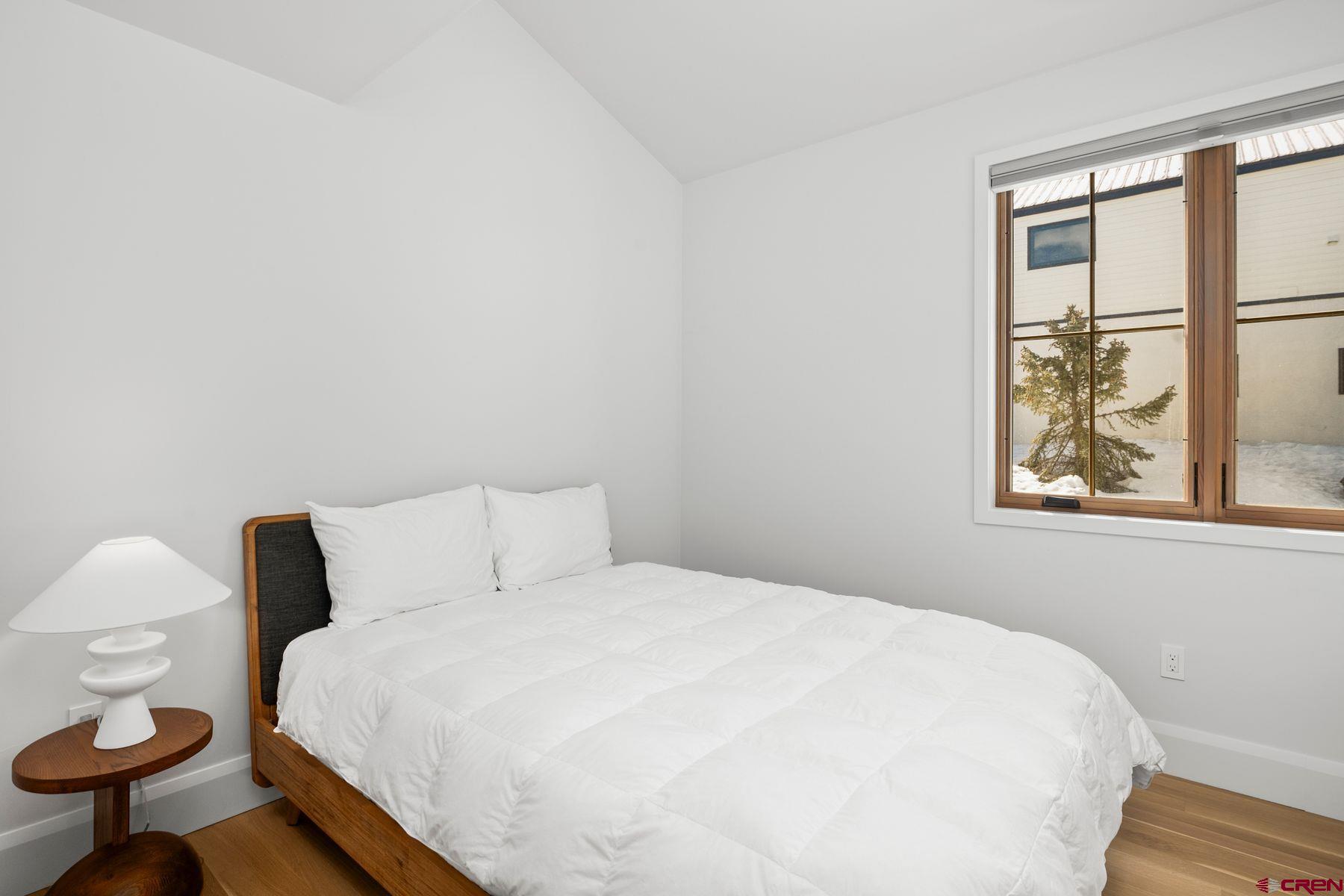 304 2nd Street Crested Butte, CO 81224 - Photo 15 of 37 a bedroom with a bed and a window