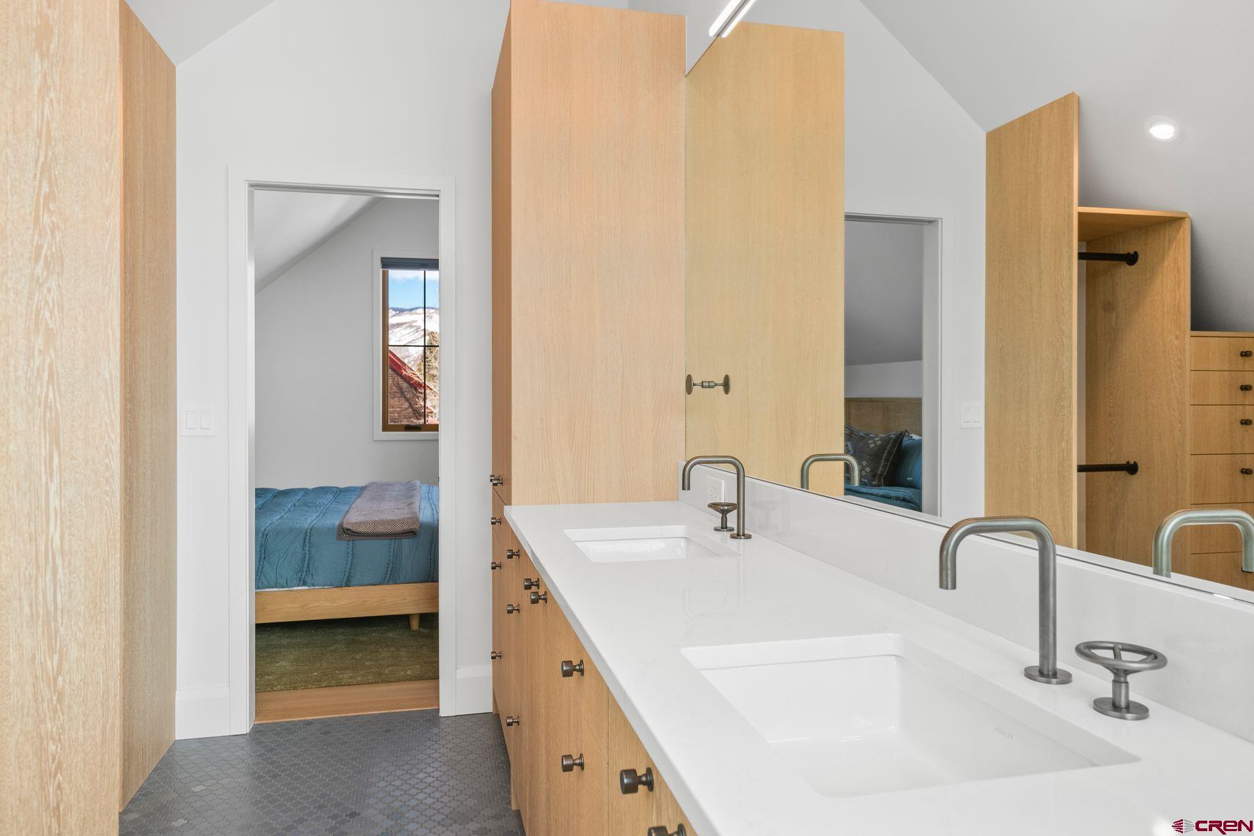 304 2nd Street Crested Butte, CO 81224 - Photo 17 of 37 a bathroom with a double vanity sink and a mirror