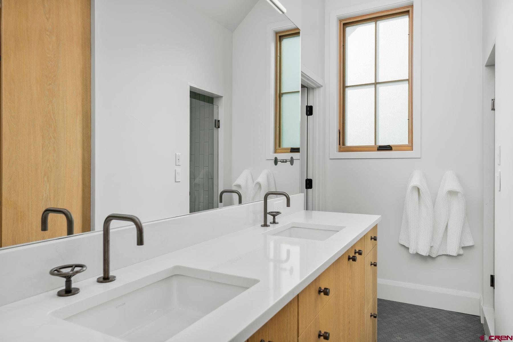 304 2nd Street Crested Butte, CO 81224 - Photo 18 of 37 a bathroom with a double vanity sink with a mirror