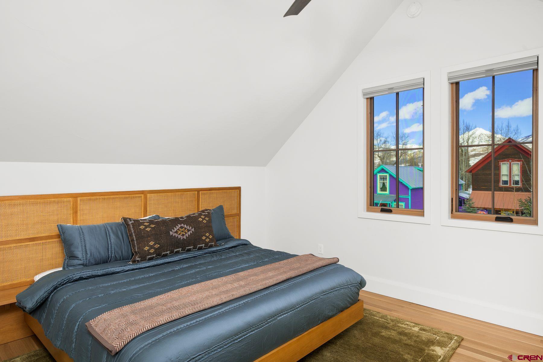 304 2nd Street Crested Butte, CO 81224 - Photo 19 of 37 a bed sitting in a bedroom next to a window