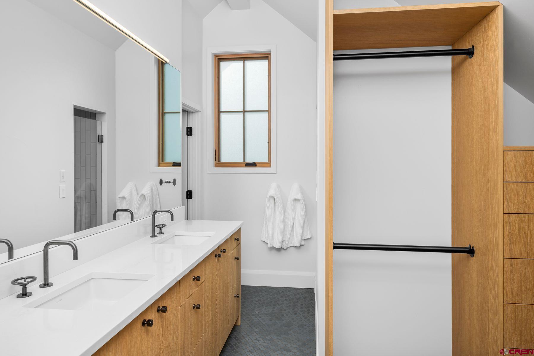 304 2nd Street Crested Butte, CO 81224 - Photo 22 of 37 a bathroom with a double vanity sink and mirror